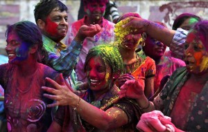 People smear colored powder on each other during Holi festivities in Mumbai, India, Monday, March 1, 2010. Holi, the Hindu festival of colors that also heralds the coming of spring, is being celebrated across the country Monday. (AP Photo/Rafiq Maqbool)